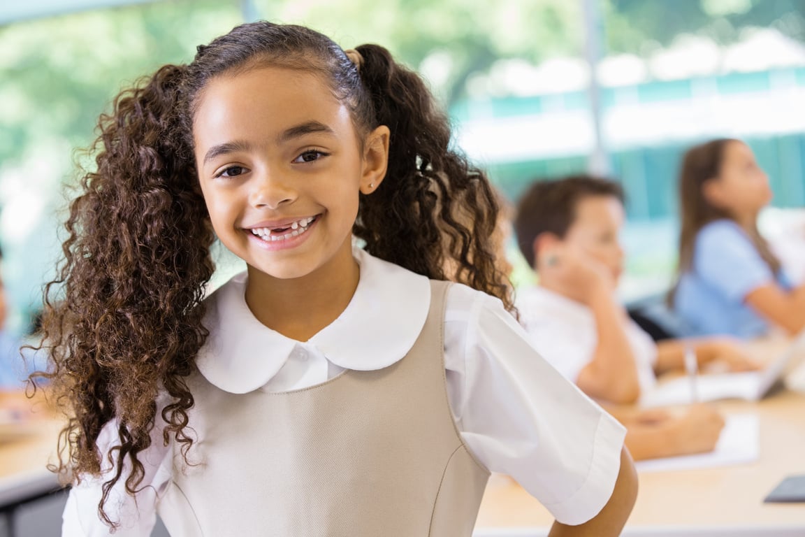 Adorable mixed race student in private school uniform